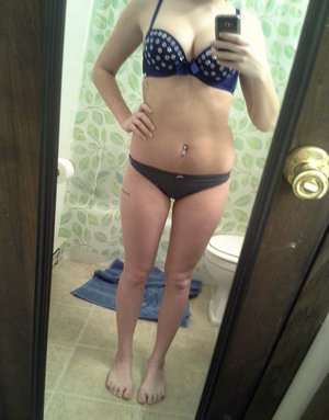 18 year old girl Megan Rain removes her sandals and then clothes to pose naked